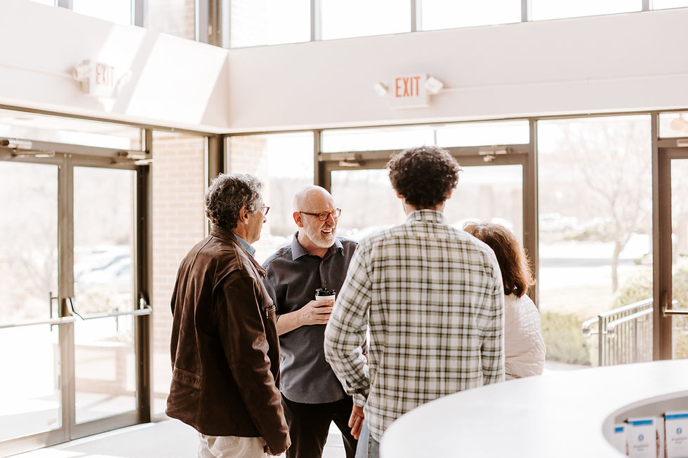 A group of 4 people gathered together talking