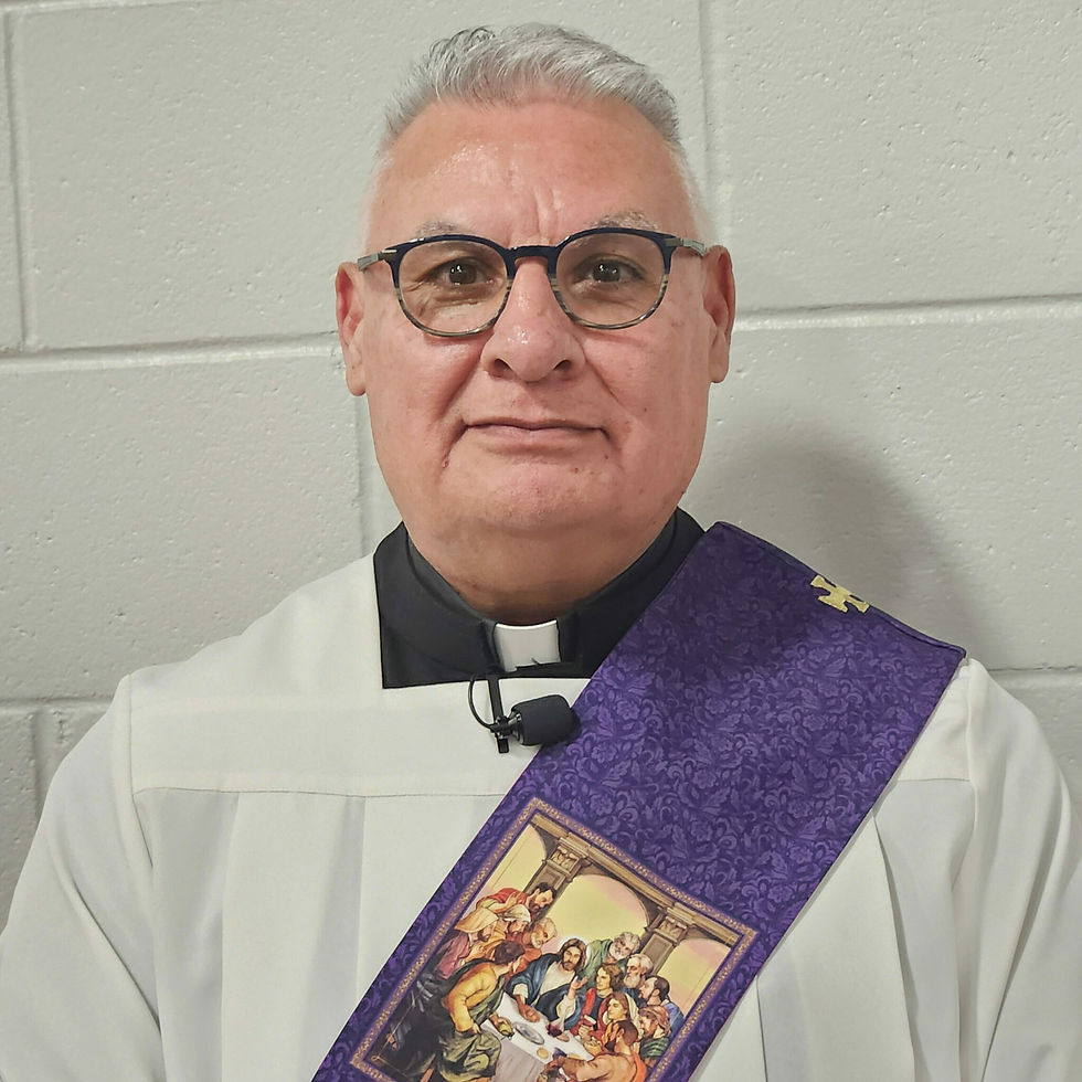 A priest in a green cassock smiling