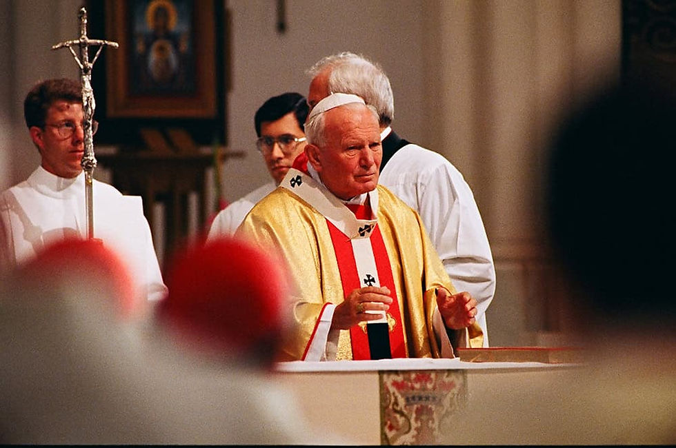 John Paul II saying Mass with altar servers around him